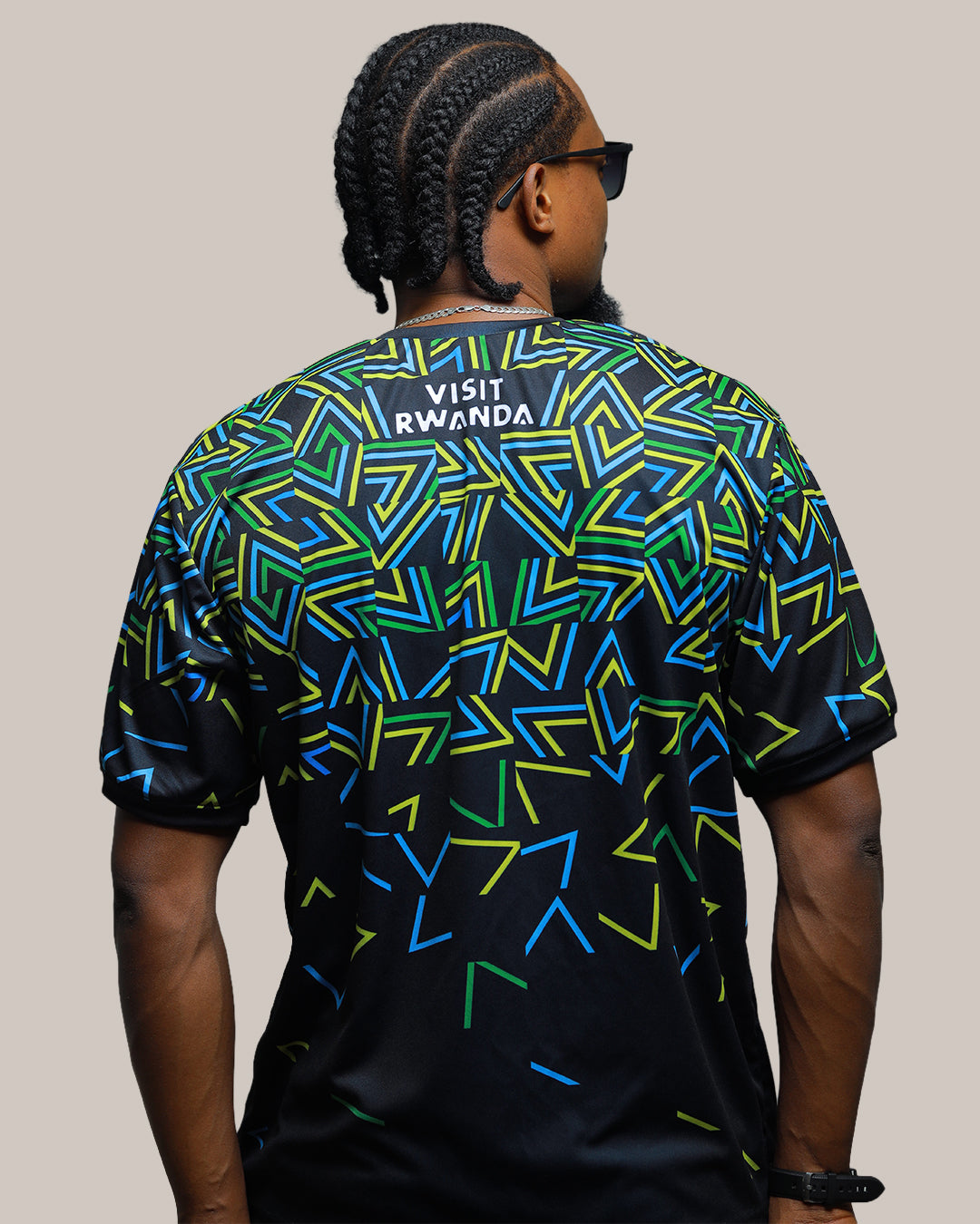 Rwanda Inkuba black football jersey back view with thunder pattern in flag colors worn by model